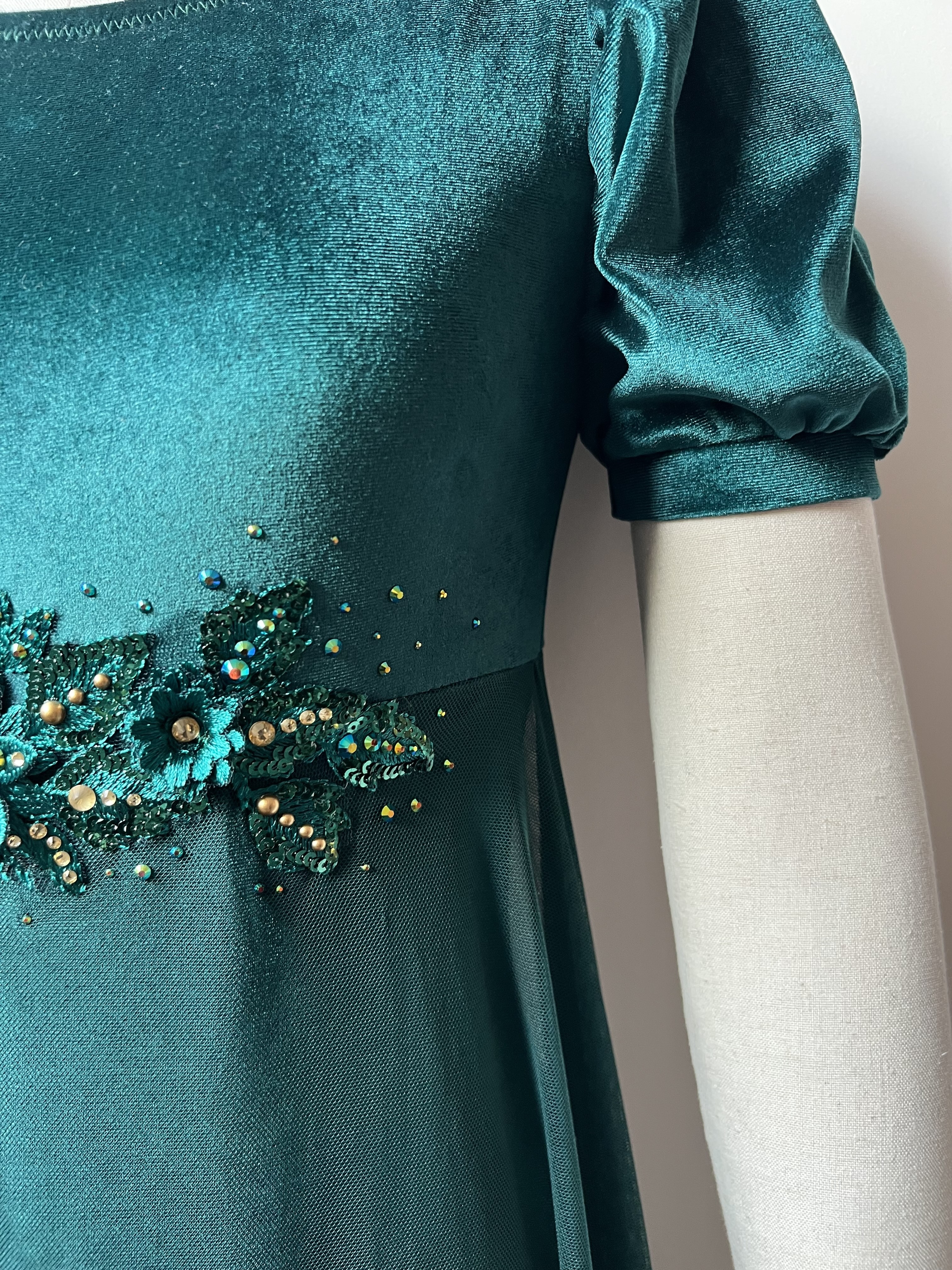 Teal costume with embellishments